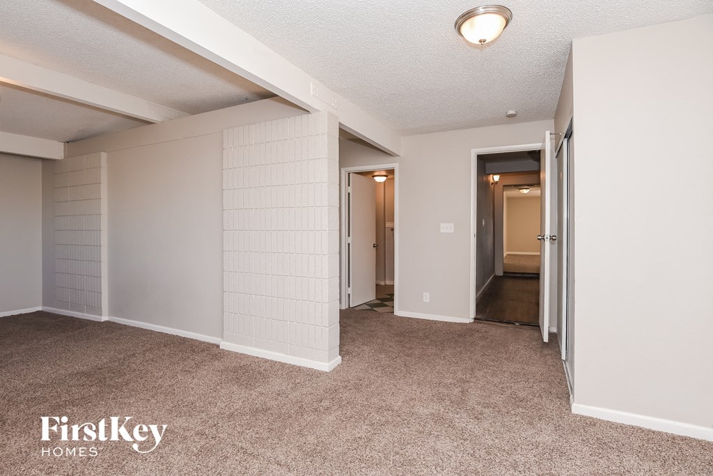 a bedroom with a closet and a hallway with a door to a bathroom