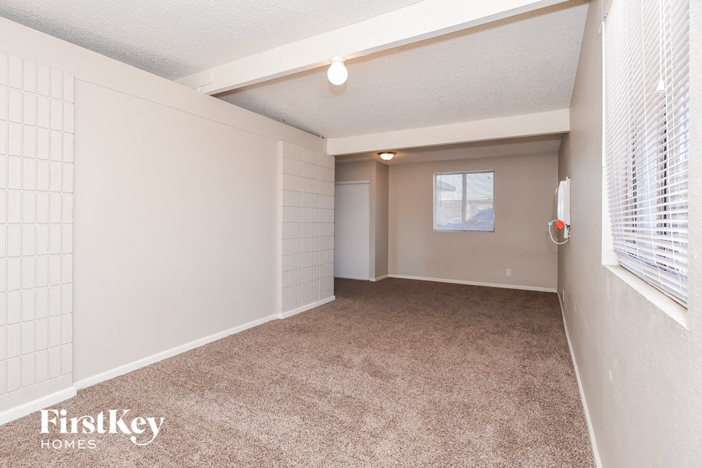a room with a carpeted floor and a window