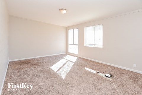 a living room with carpet and a window