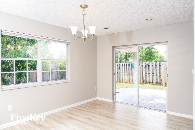 an empty living room with a sliding glass door to a patio
