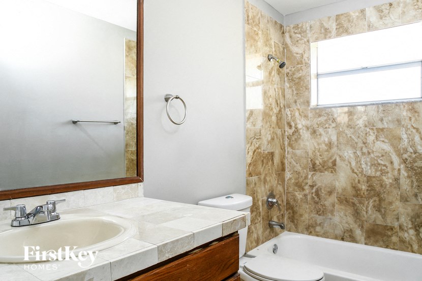 a bathroom with a sink toilet and a tub