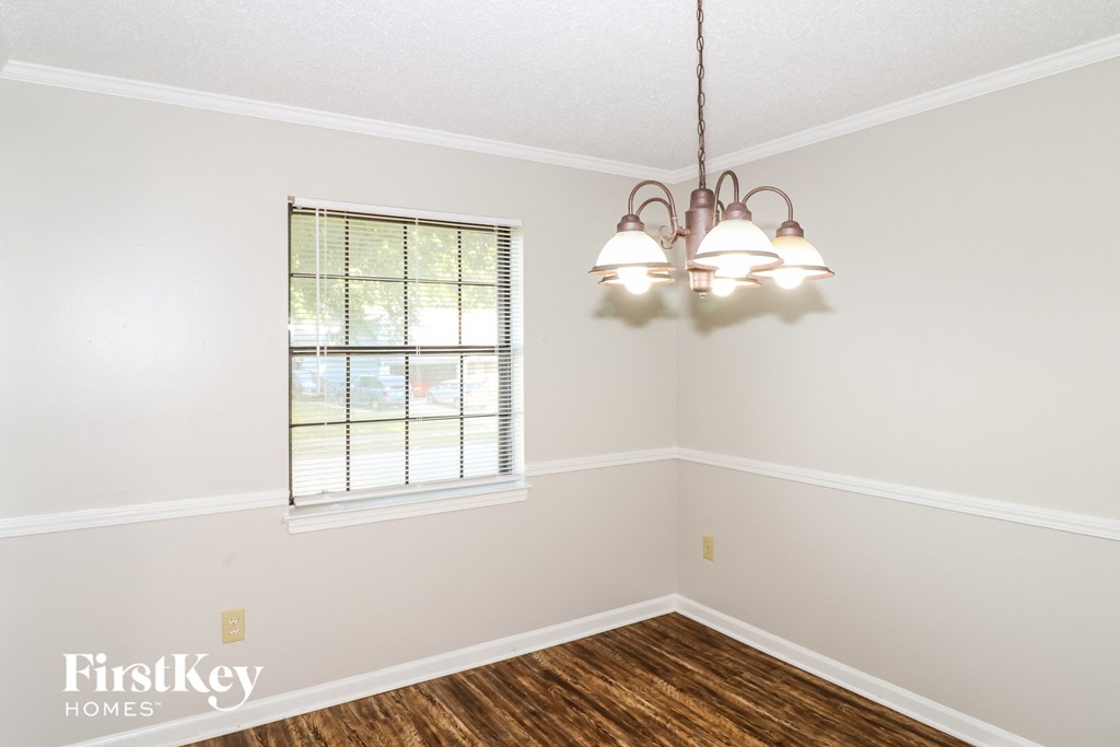 a living room with a window and a chandelier