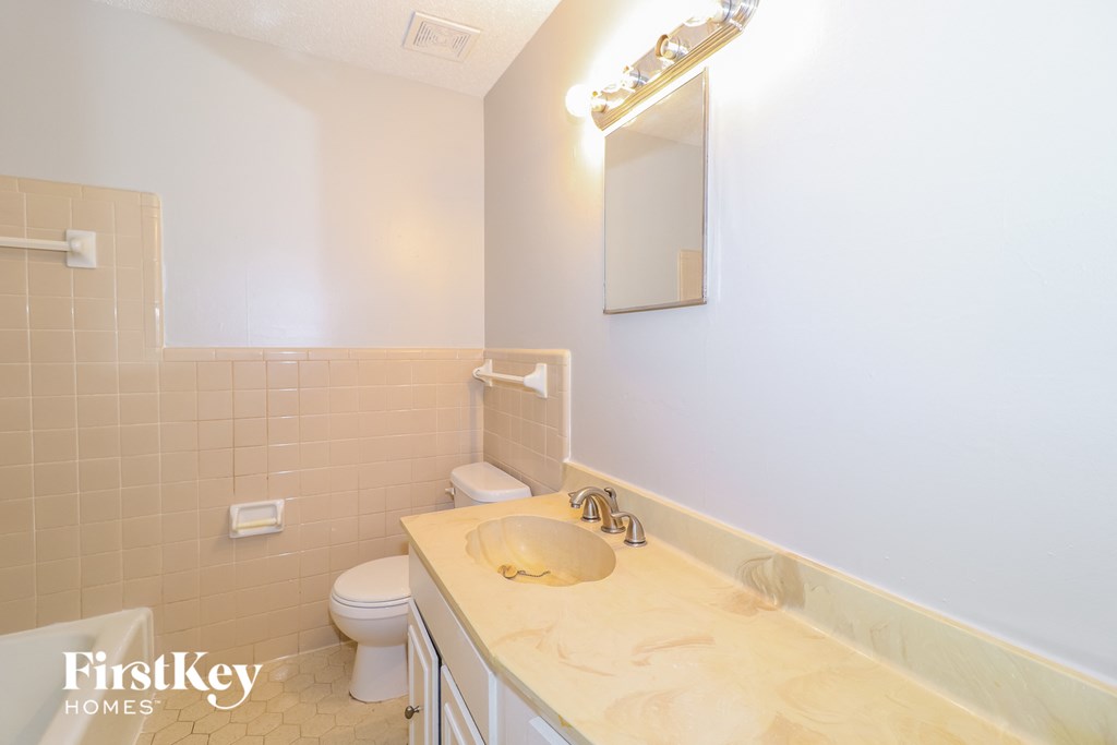 a white bathroom with a sink and a toilet