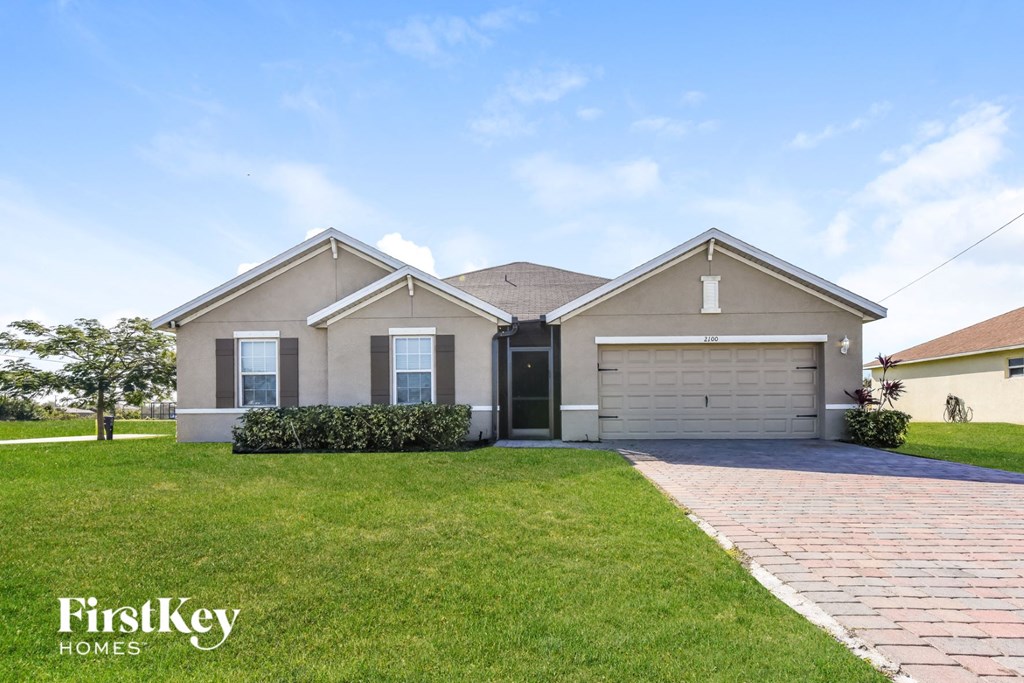 a house with a lawn and a driveway