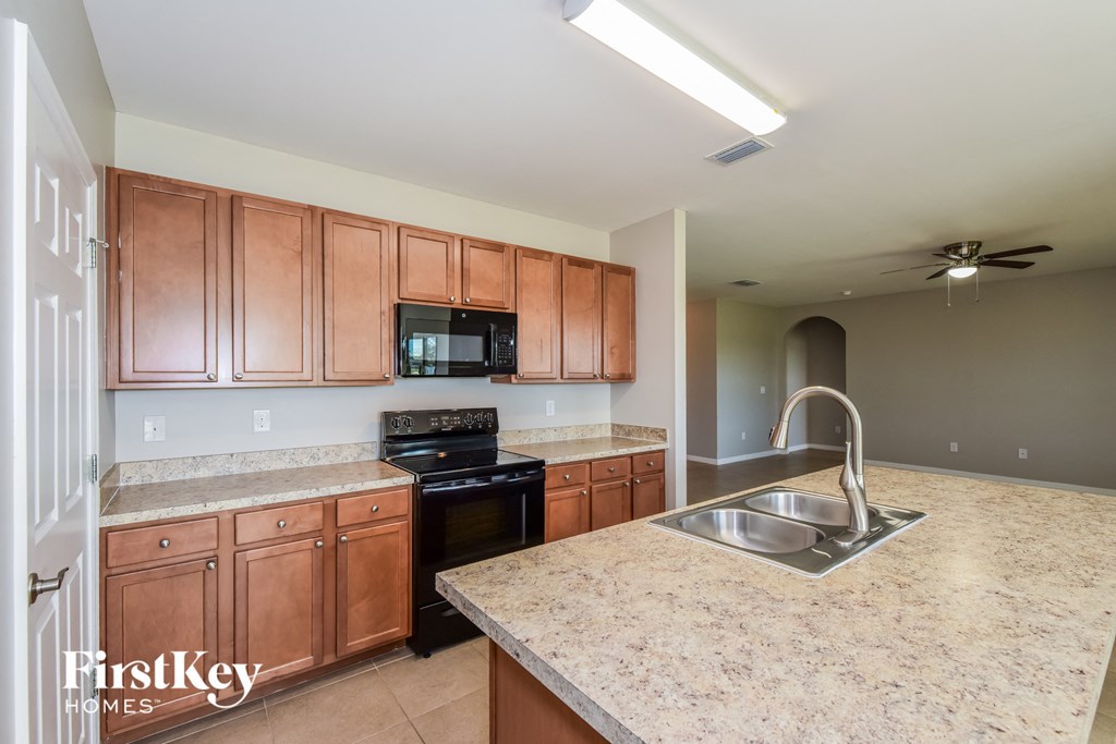 a kitchen with wood cabinets and granite counter tops and a sink