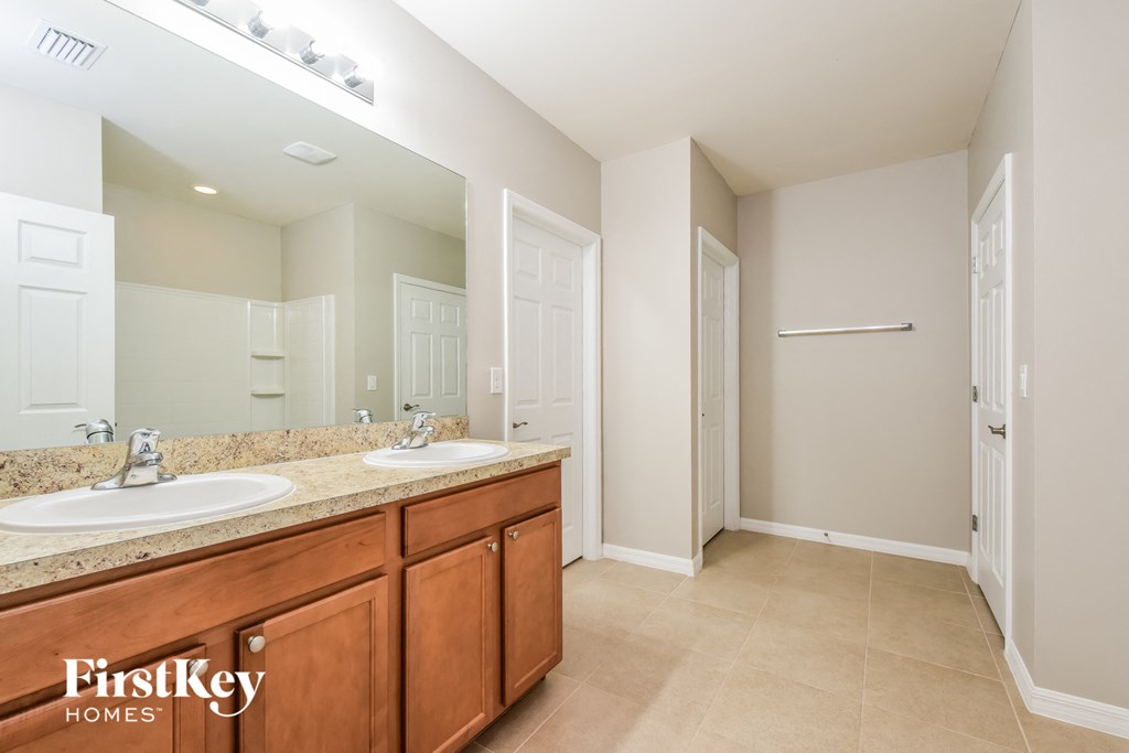 a bathroom with two sinks and a large mirror