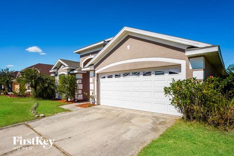 a house with a white garage door in front of a driveway