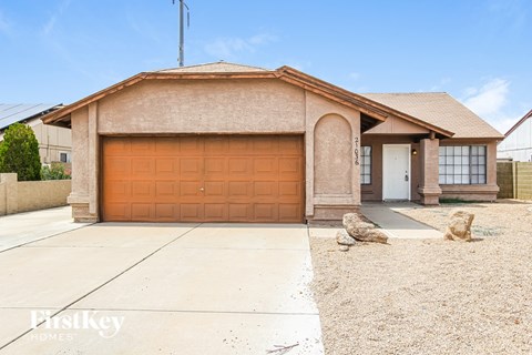 A house with a brown garage door is for sale.