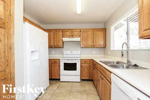 A kitchen with wooden cabinets and a white refrigerator.