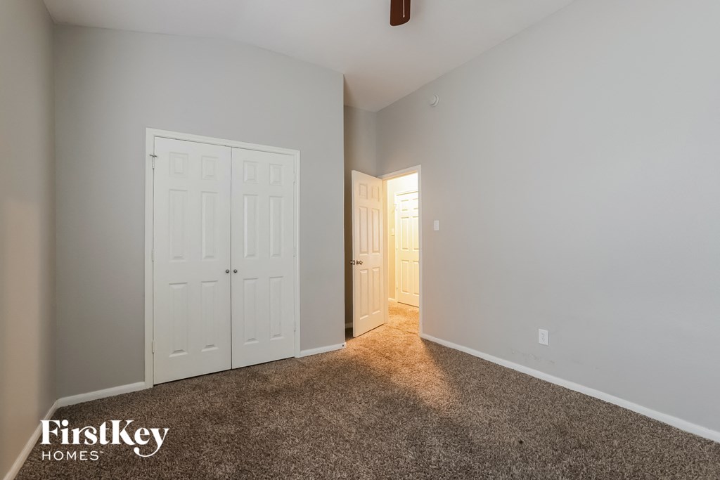 a bedroom with two closets and a door to a hallway