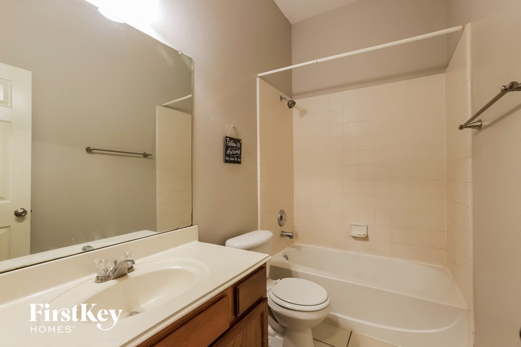 a bathroom with a sink and a toilet and a bath tub