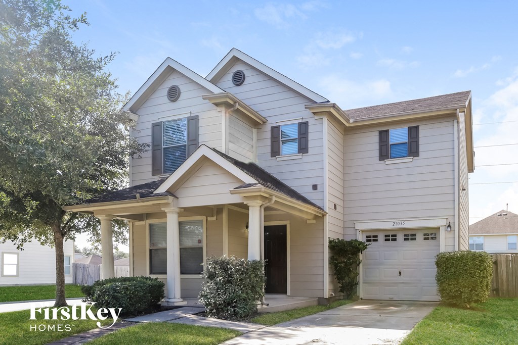 a white house with white siding and a garage
