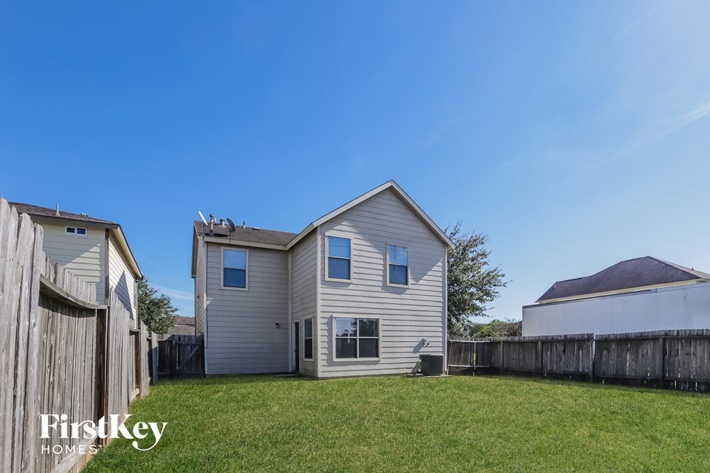 a white house with a yard and a fence