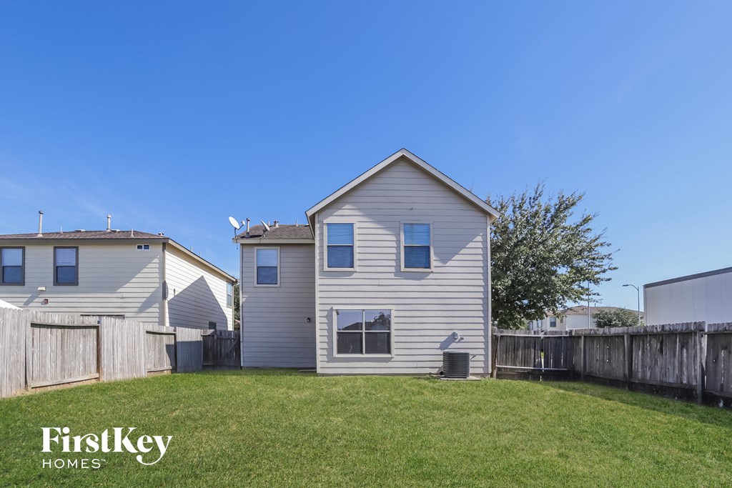 a white house with a yard and a fence
