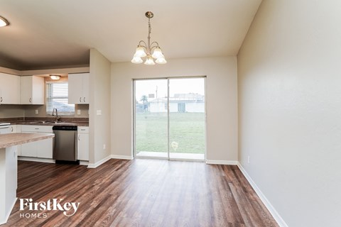 A kitchen with a dishwasher and a chandelier.