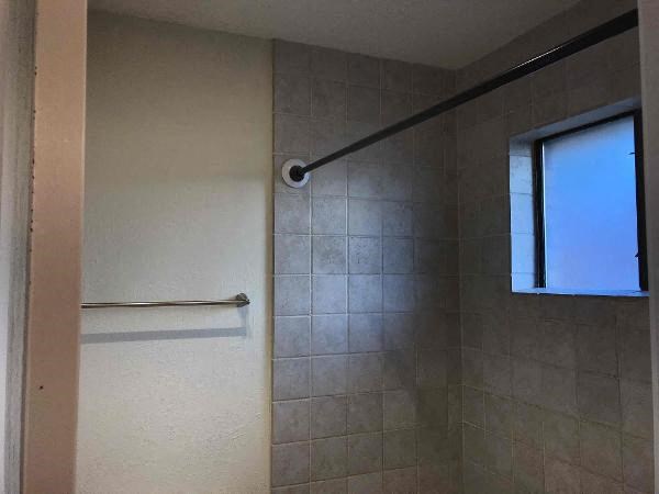 a bathroom with a shower curtain and a window