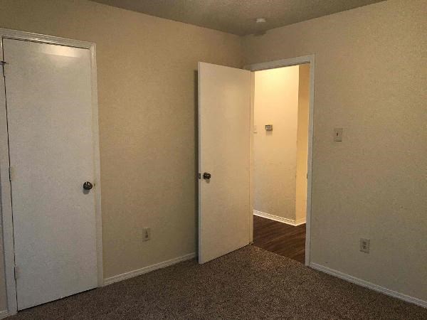 an empty room with two open doors