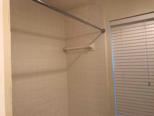a bathroom with a shower and a curtain