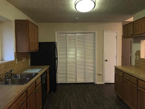 a kitchen with a sink and a refrigerator