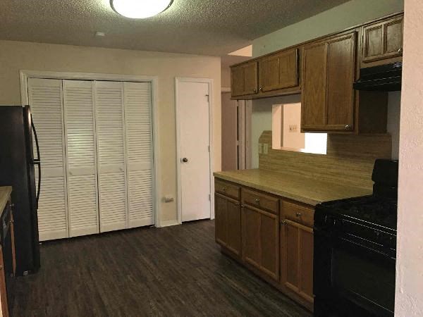 a kitchen with a stove and a refrigerator