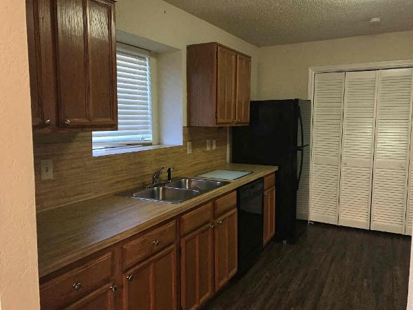 a kitchen with a sink and a refrigerator