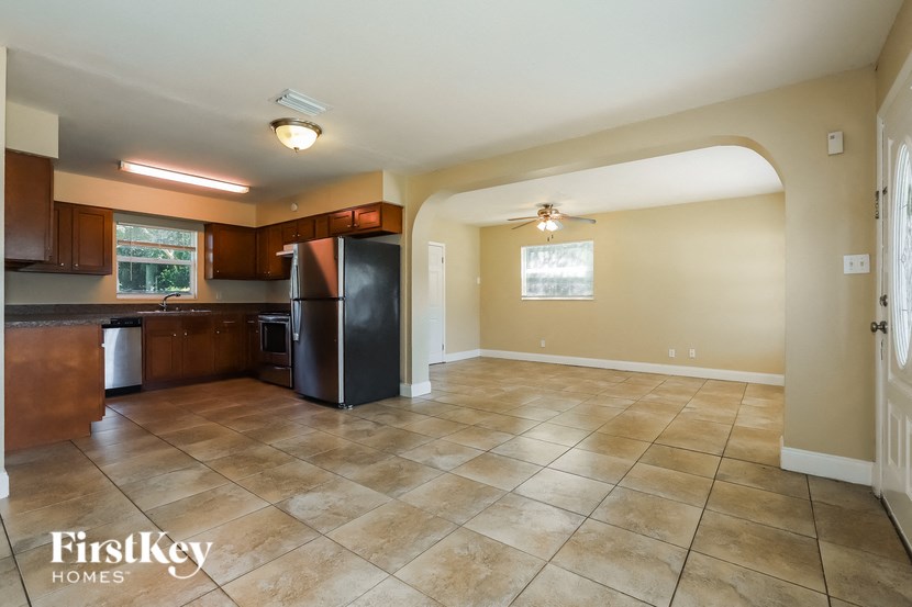 an empty kitchen with a refrigerator and a sink