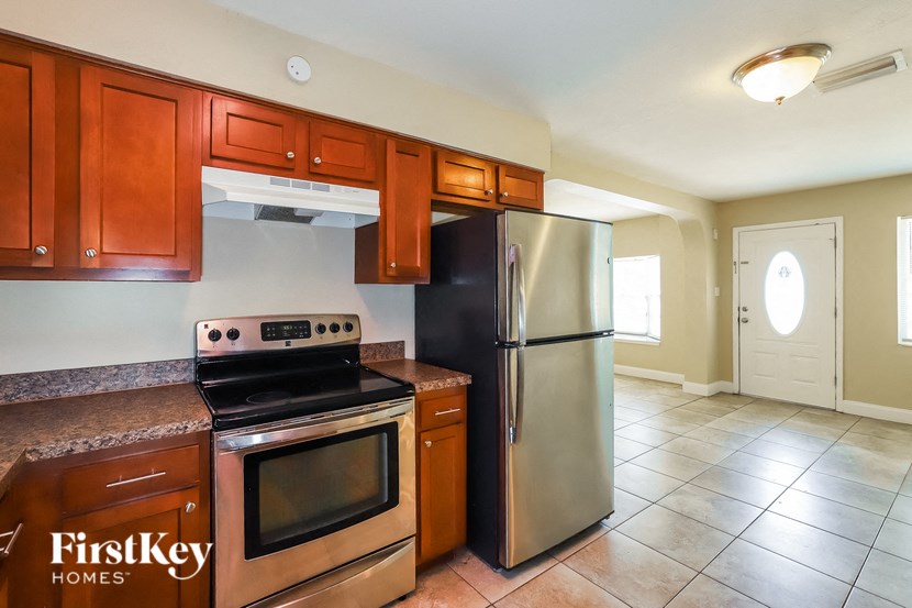 a kitchen with stainless steel appliances and wooden cabinets