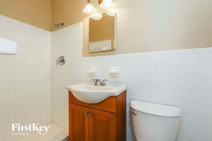 a bathroom with a toilet and a sink and a mirror