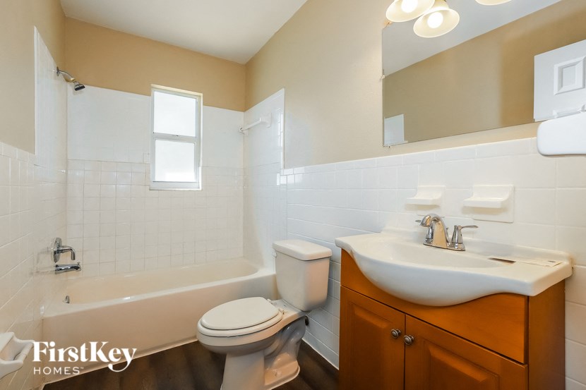 a bathroom with a sink toilet and a bath tub