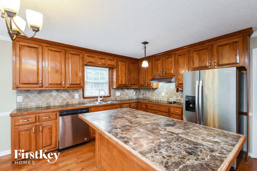 a kitchen with wooden cabinets and granite counter tops