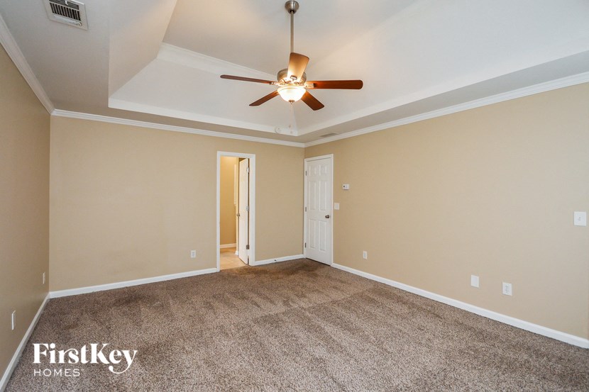 the living room of a house with a ceiling fan