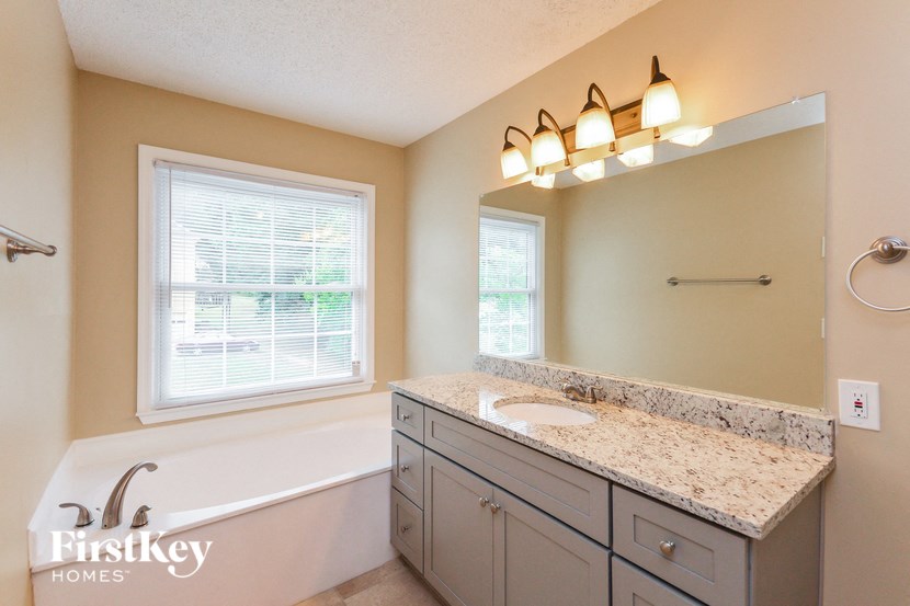 a bathroom with a sink and a bath tub