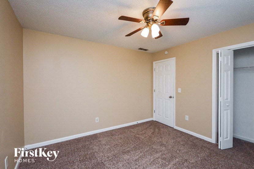 the living room of a home with a ceiling fan