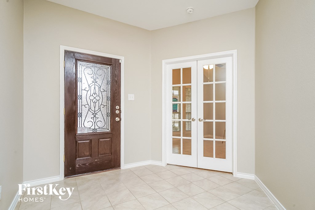 A room with a brown door and a white door with frosted glass.