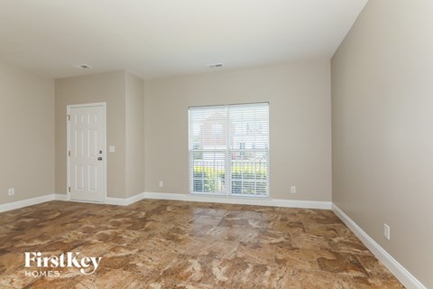 a empty room with a window and a door