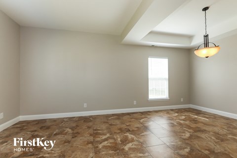 the living room after remodeling with new flooring and a ceiling fan