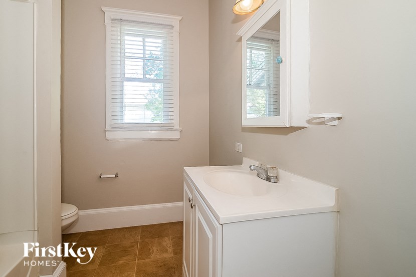 a bathroom with a white sink and a toilet