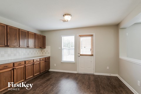 A kitchen with wooden cabinets and a tiled backsplash.