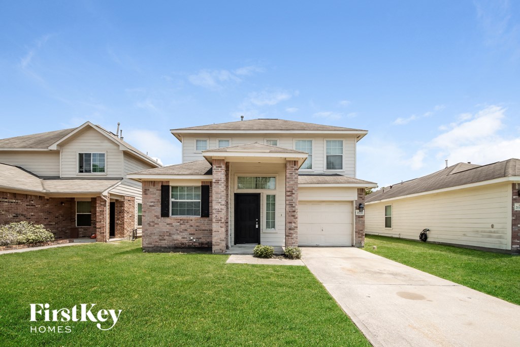 A house with a driveway in front of it.