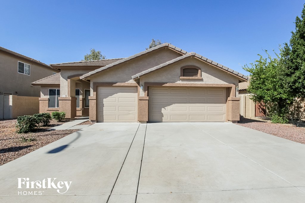 a spacious driveway in front of a house with a garage door