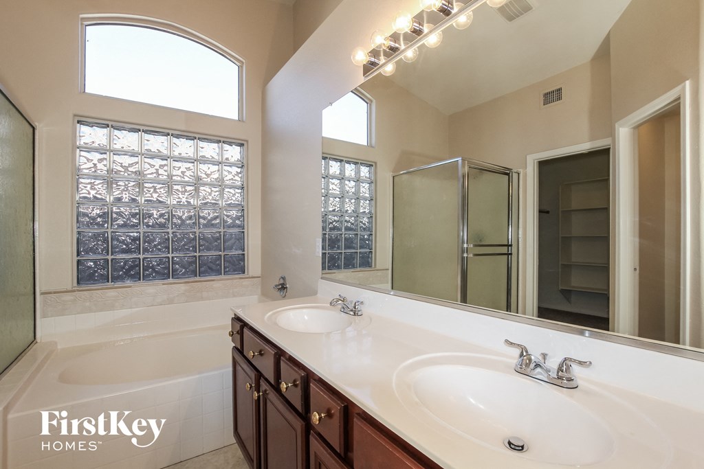 two sinks in a bathroom with a large mirror