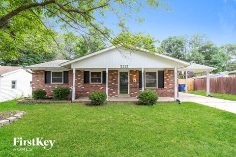 A house with the number 2112 on it is for sale.