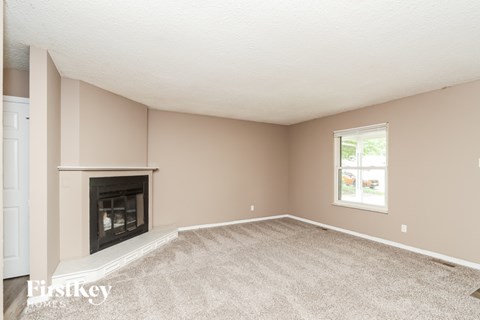A room with a fireplace and a window.