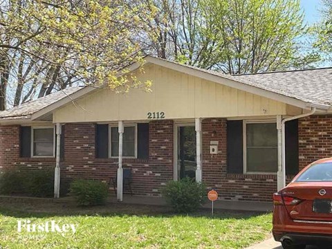 A brick house with the number 2112 on the front.
