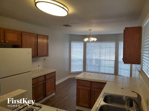 a kitchen with a sink and a refrigerator