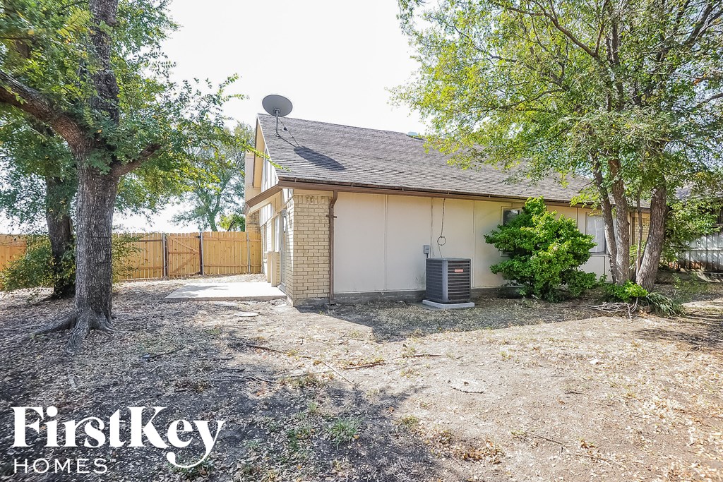 a small brick house with a yard and trees