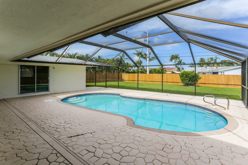 a swimming pool is under a glass roof next to a pool