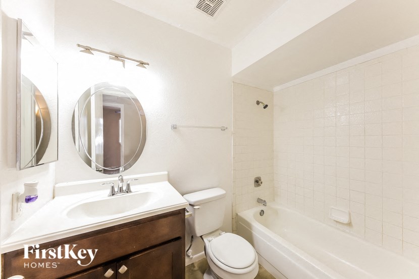 a bathroom with a sink toilet and bath tub