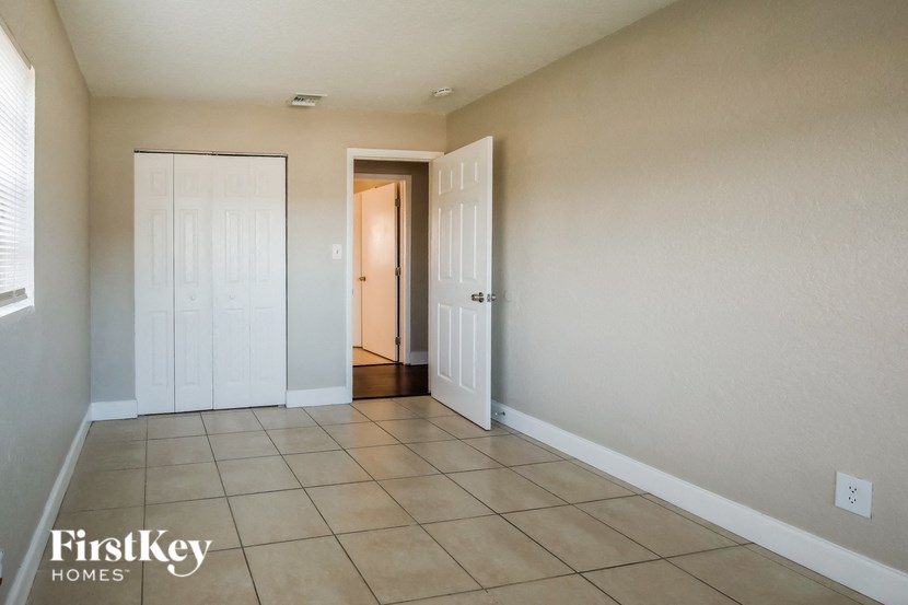 A room with a white door and a white closet door.