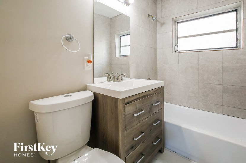 A white toilet sits next to a sink in a bathroom.